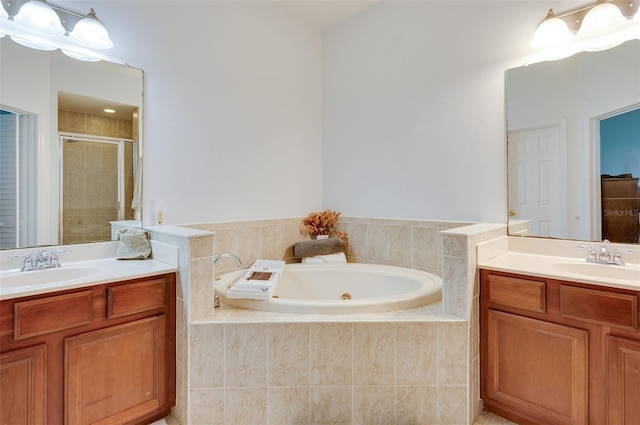 1105 Venetian Harbor Dr NE, Saint Petersburg, FL 33702 - bathroom featuring a stall shower, two vanities, and a tub with jets