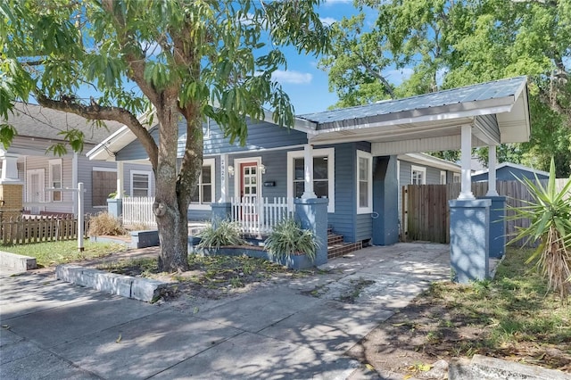 2920 N 11th St, Tampa, FL 33605 - view of front facade with a porch, metal roof, and fence