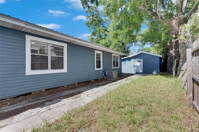 2920 N 11th St, Tampa, FL 33605 - view of side of property with central air condition unit, a storage unit, fence, and an outdoor structure