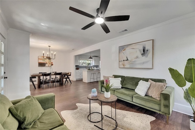 2920 N 11th St, Tampa, FL 33605 - living room featuring visible vents, baseboards, ornamental molding, dark wood-style floors, and ceiling fan with notable chandelier