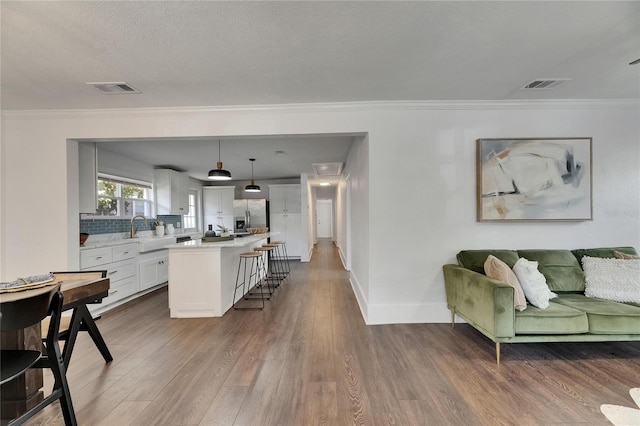 2920 N 11th St, Tampa, FL 33605 - living room featuring visible vents, crown molding, and wood finished floors