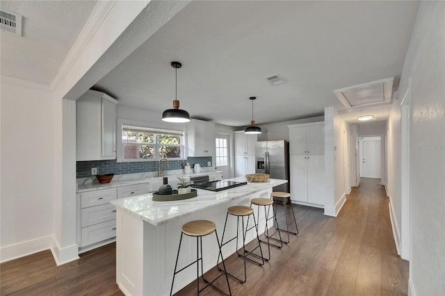 2920 N 11th St, Tampa, FL 33605 - kitchen with visible vents, a center island, stainless steel refrigerator with ice dispenser, and black electric stovetop