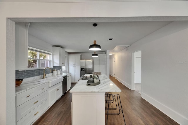 2920 N 11th St, Tampa, FL 33605 - kitchen with tasteful backsplash, a center island, a sink, a kitchen breakfast bar, and stainless steel appliances