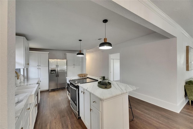 2920 N 11th St, Tampa, FL 33605 - kitchen featuring dark wood finished floors, light stone countertops, white cabinetry, a kitchen island, and stainless steel appliances