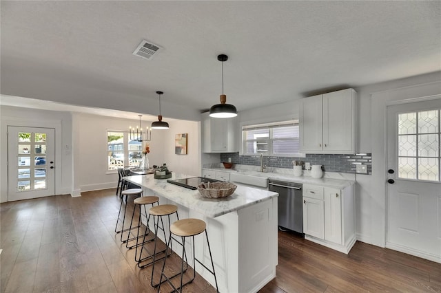 2920 N 11th St, Tampa, FL 33605 - kitchen with stainless steel dishwasher, dark wood-type flooring, visible vents, and black electric stovetop