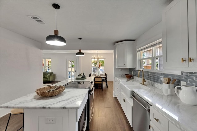 2920 N 11th St, Tampa, FL 33605 - kitchen with white cabinets, light stone countertops, visible vents, dark wood finished floors, and appliances with stainless steel finishes