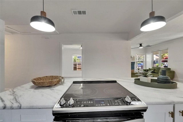 2920 N 11th St, Tampa, FL 33605 - interior space with stainless steel electric range oven, visible vents, white cabinets, hanging light fixtures, and a ceiling fan