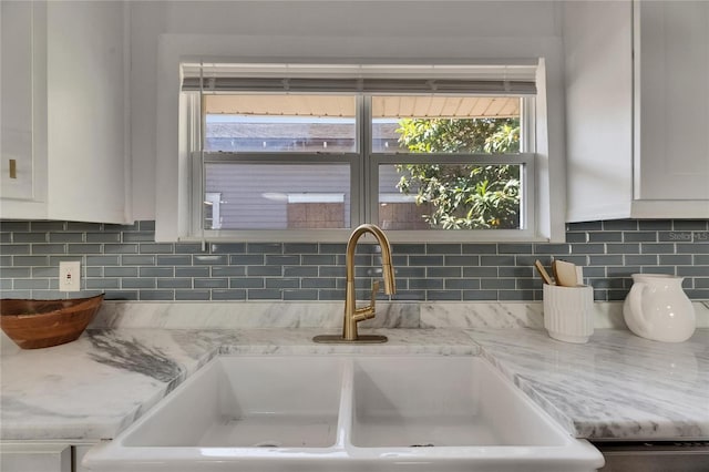 2920 N 11th St, Tampa, FL 33605 - room details with white cabinetry, a sink, backsplash, and light stone counters