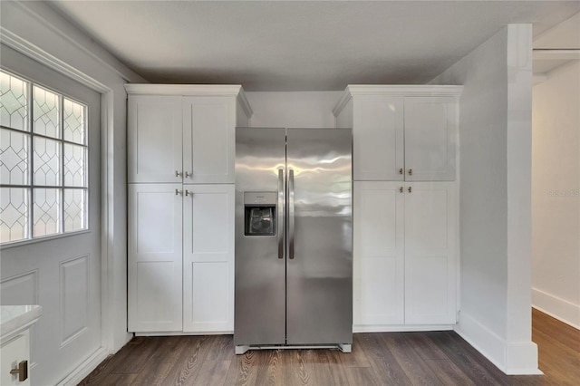 2920 N 11th St, Tampa, FL 33605 - kitchen with dark wood-type flooring, baseboards, white cabinets, and stainless steel refrigerator with ice dispenser