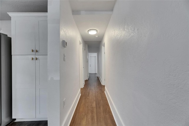 2920 N 11th St, Tampa, FL 33605 - hall with a textured wall, baseboards, and wood finished floors
