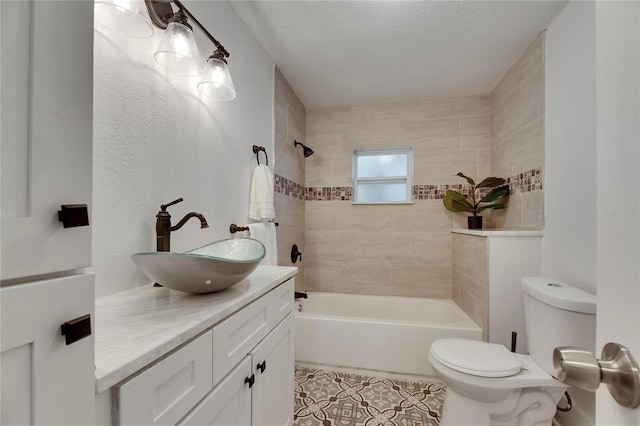 2920 N 11th St, Tampa, FL 33605 - bathroom featuring tub / shower combination, a textured ceiling, vanity, tile patterned flooring, and toilet