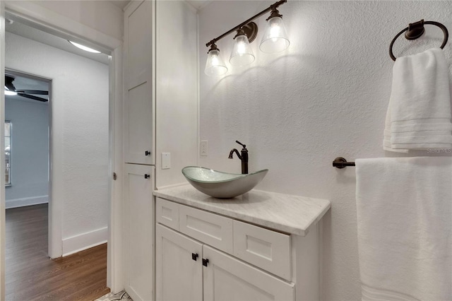 2920 N 11th St, Tampa, FL 33605 - bathroom with vanity, baseboards, and wood finished floors
