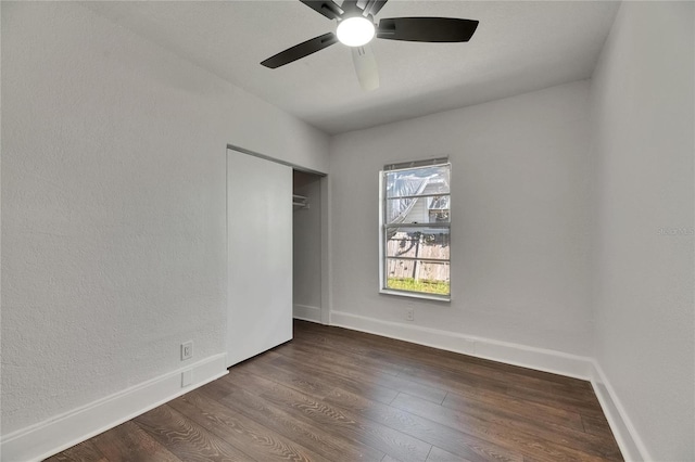 2920 N 11th St, Tampa, FL 33605 - unfurnished bedroom with a closet, dark wood-style flooring, baseboards, and a ceiling fan