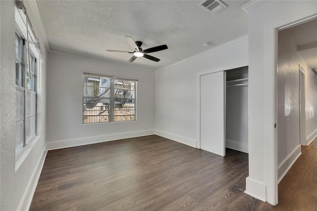 2920 N 11th St, Tampa, FL 33605 - unfurnished bedroom featuring a textured ceiling, a closet, ornamental molding, visible vents, and dark wood-style flooring