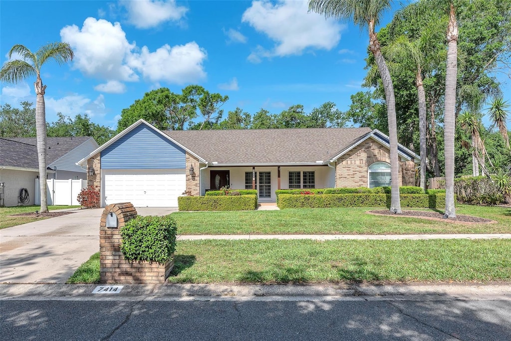 7414 Mint Julep Dr, Riverview, FL 33578 - single story home with a garage, a front lawn, and brick siding