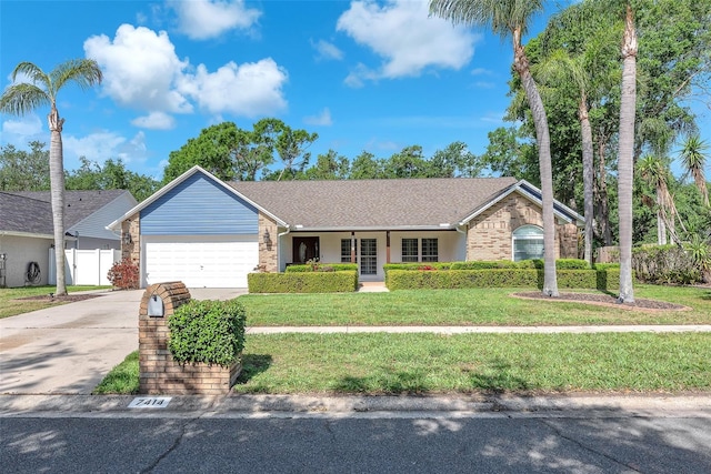 7414 Mint Julep Dr, Riverview, FL 33578 - single story home with a garage, a front lawn, and brick siding