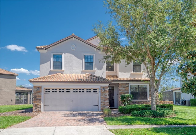 1401 Wexford Way, Davenport, FL 33896 - view of front facade with decorative driveway, stone siding, stucco siding, and a tiled roof