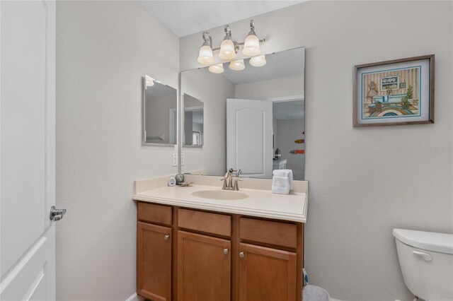 1401 Wexford Way, Davenport, FL 33896 - bathroom with vanity, toilet, and baseboards
