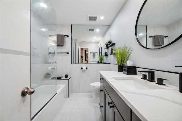 bathroom with toilet, a garden tub, vanity, and visible vents