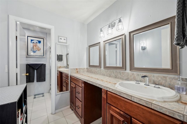 full bathroom featuring double vanity, a sink, and tile patterned flooring