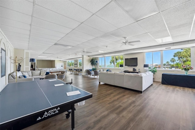 playroom with a drop ceiling, wood finished floors, and ceiling fan