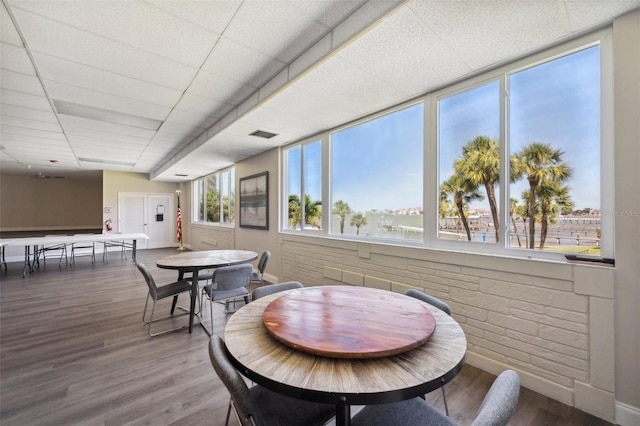 dining room with wood finished floors, baseboards, and visible vents