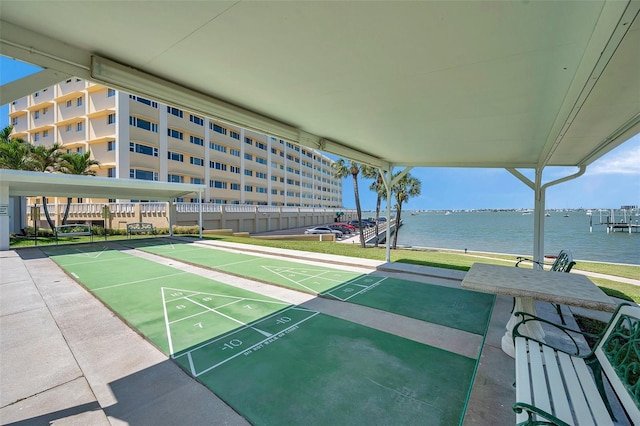 view of home's community featuring a water view and shuffleboard