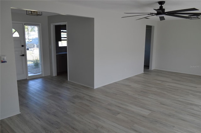 spare room with wood finished floors and ceiling fan
