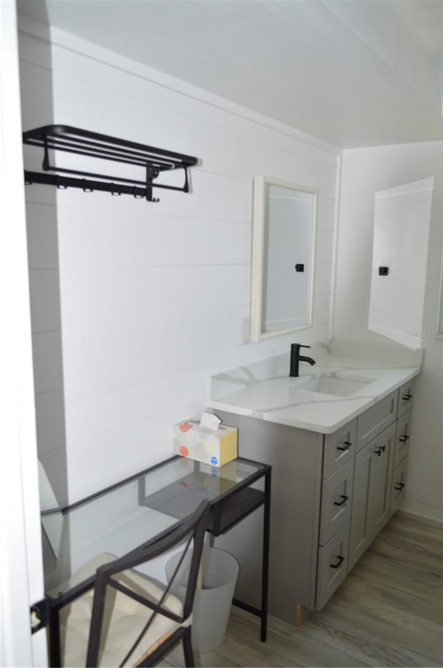 bathroom with vanity and wood finished floors