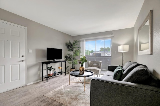 living room with wood finished floors and baseboards