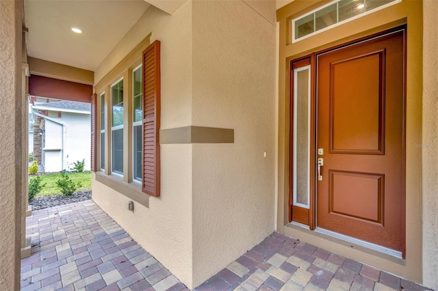 entrance to property with stucco siding