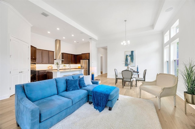 living area with light wood-type flooring, visible vents, recessed lighting, baseboards, and a notable chandelier