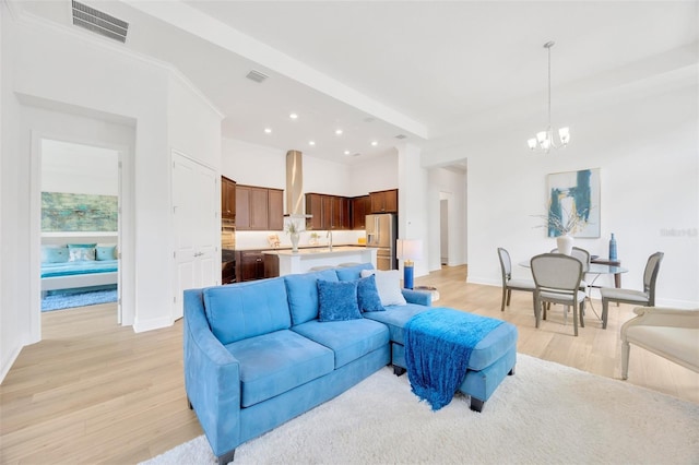 living area featuring visible vents, baseboards, a chandelier, recessed lighting, and light wood-style flooring
