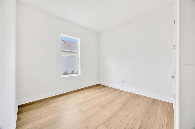 unfurnished room with light wood-type flooring and baseboards