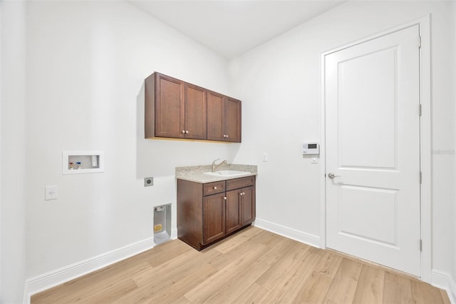 laundry room with light wood-style floors, hookup for an electric dryer, washer hookup, a sink, and baseboards