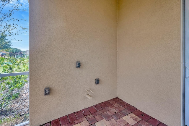 laundry area featuring brick floor