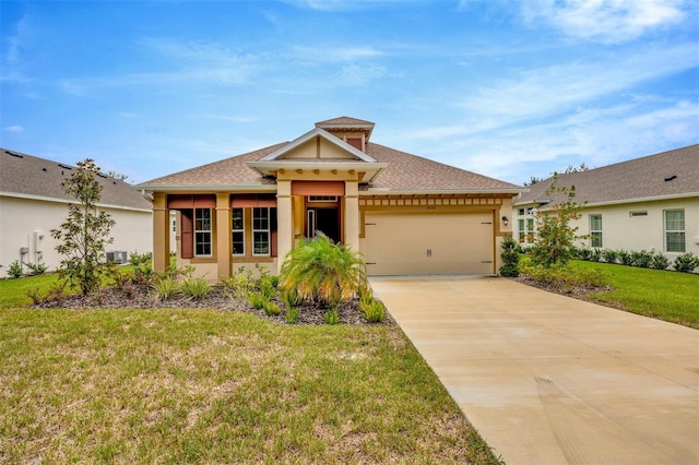 view of front facade with a front yard, driveway, stucco siding, and an attached garage