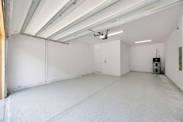 garage featuring electric panel, a garage door opener, and hybrid water heater