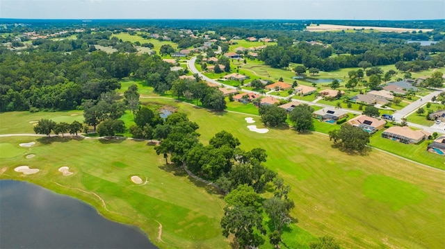 drone / aerial view with a water view, golf course view, and a residential view