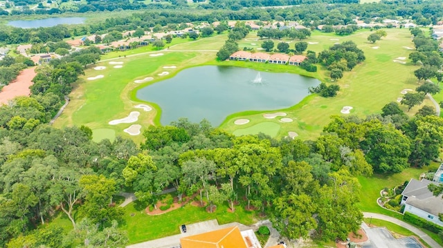 drone / aerial view featuring golf course view and a water view