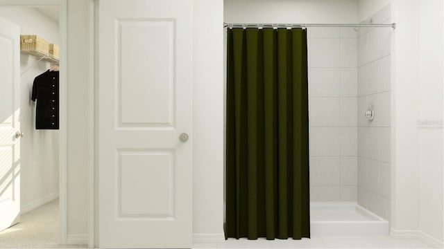 full bathroom featuring a tile shower, radiator, and baseboards
