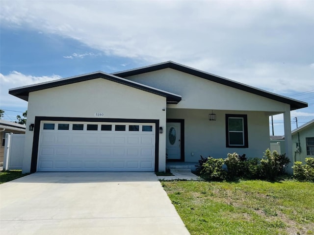 single story home with an attached garage, driveway, stucco siding, and a porch
