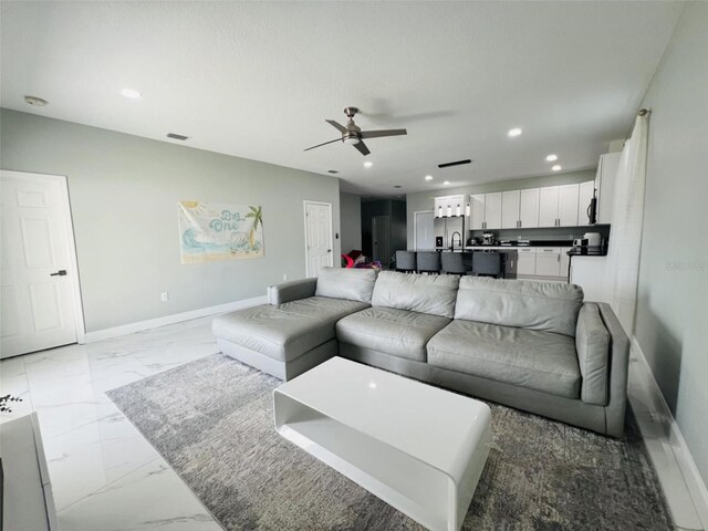 living area with recessed lighting, marble finish floor, baseboards, visible vents, and a ceiling fan