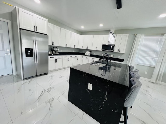 kitchen featuring appliances with stainless steel finishes, recessed lighting, marble finish floor, and a sink