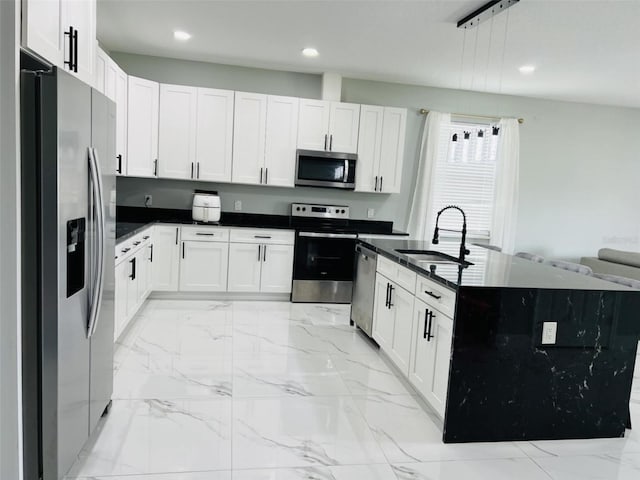 kitchen with recessed lighting, stainless steel appliances, dark countertops, and a sink