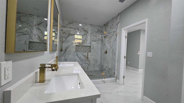 bathroom with double vanity, marble finish floor, a sink, baseboards, and a marble finish shower