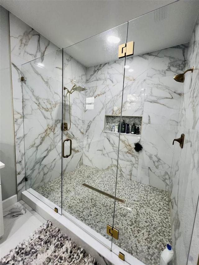 full bathroom featuring marble finish floor and a marble finish shower