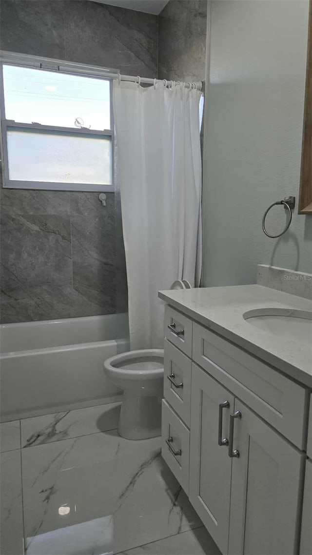 bathroom with shower / tub combo, toilet, vanity, and marble finish floor