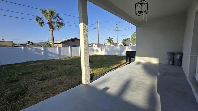 view of yard featuring cooling unit, a patio area, and a fenced backyard