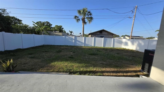 view of yard featuring central air condition unit and fence